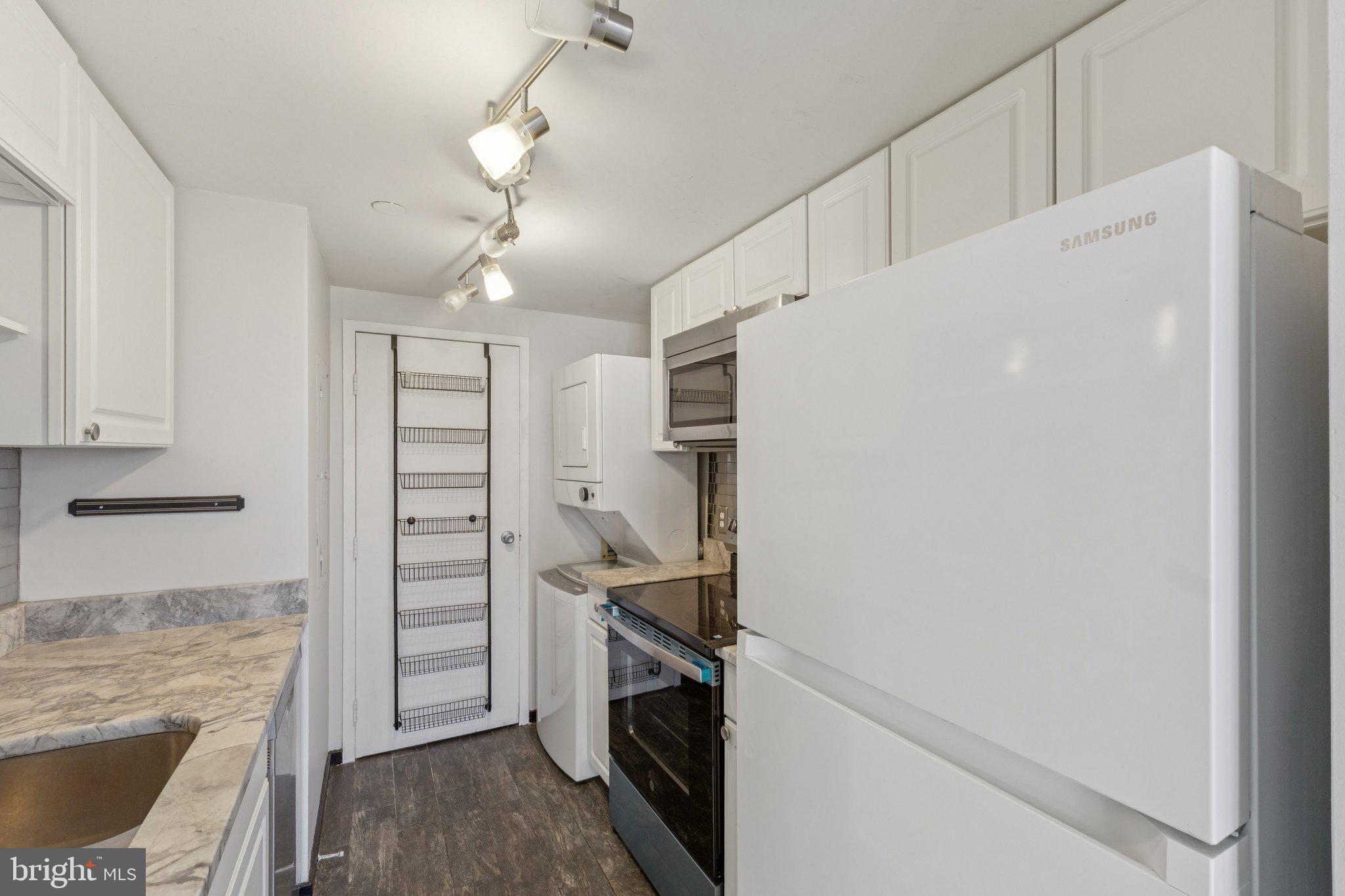 1530 Key Boulevard, Unit 929 Arlington, VA 22209 - Photo 11 of 37 a kitchen with cabinets and stainless steel appliances
