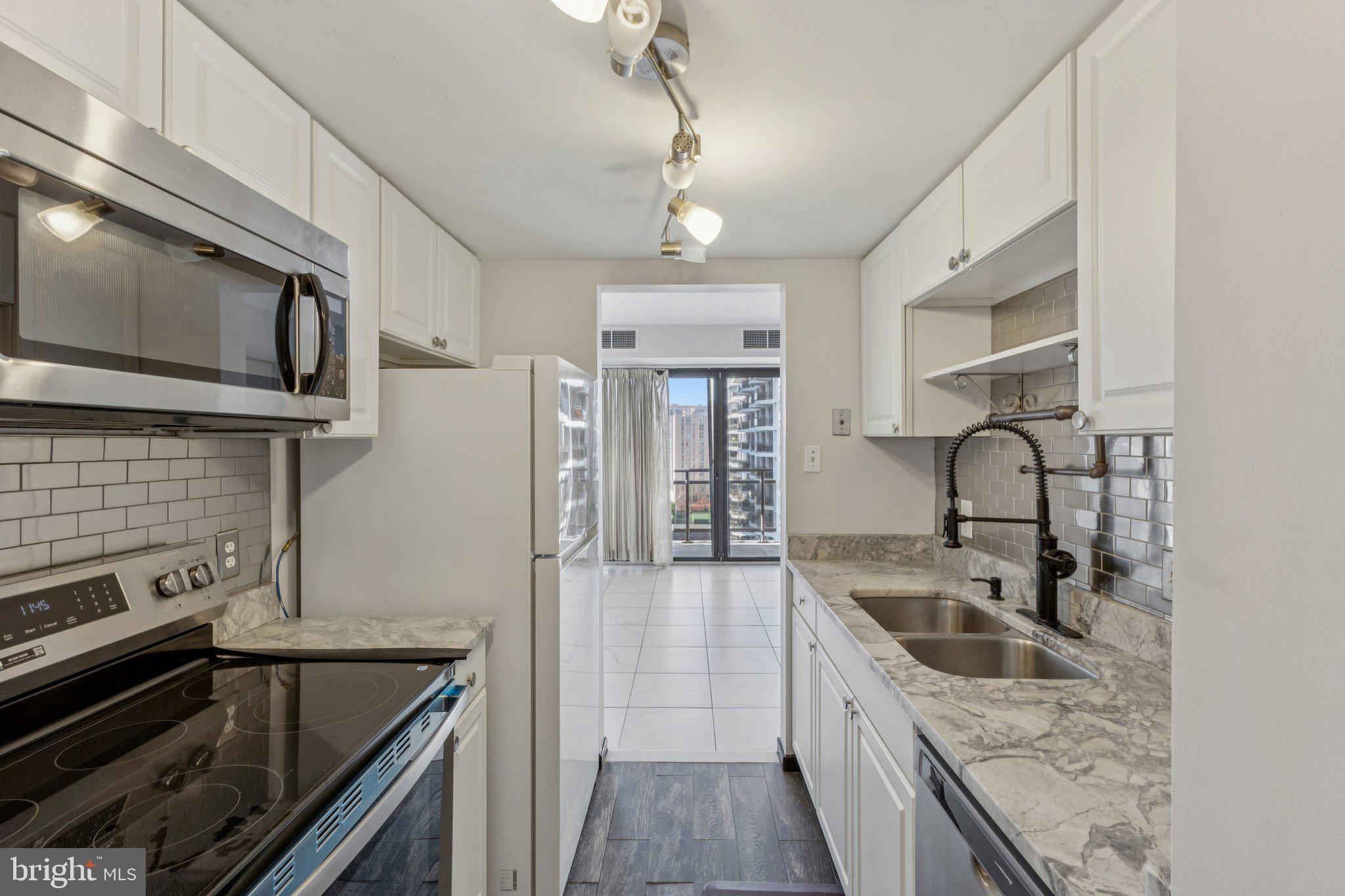 1530 Key Boulevard, Unit 929 Arlington, VA 22209 - Photo 12 of 37 a kitchen with stainless steel appliances granite countertop a sink and stove