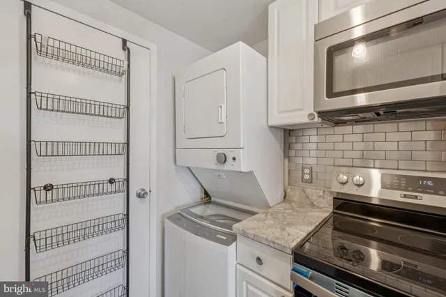 a kitchen with granite countertop white cabinets and appliances