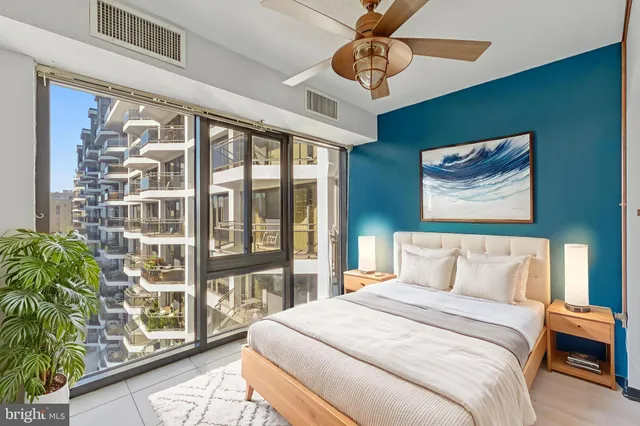 a bedroom with a large bed and a large window