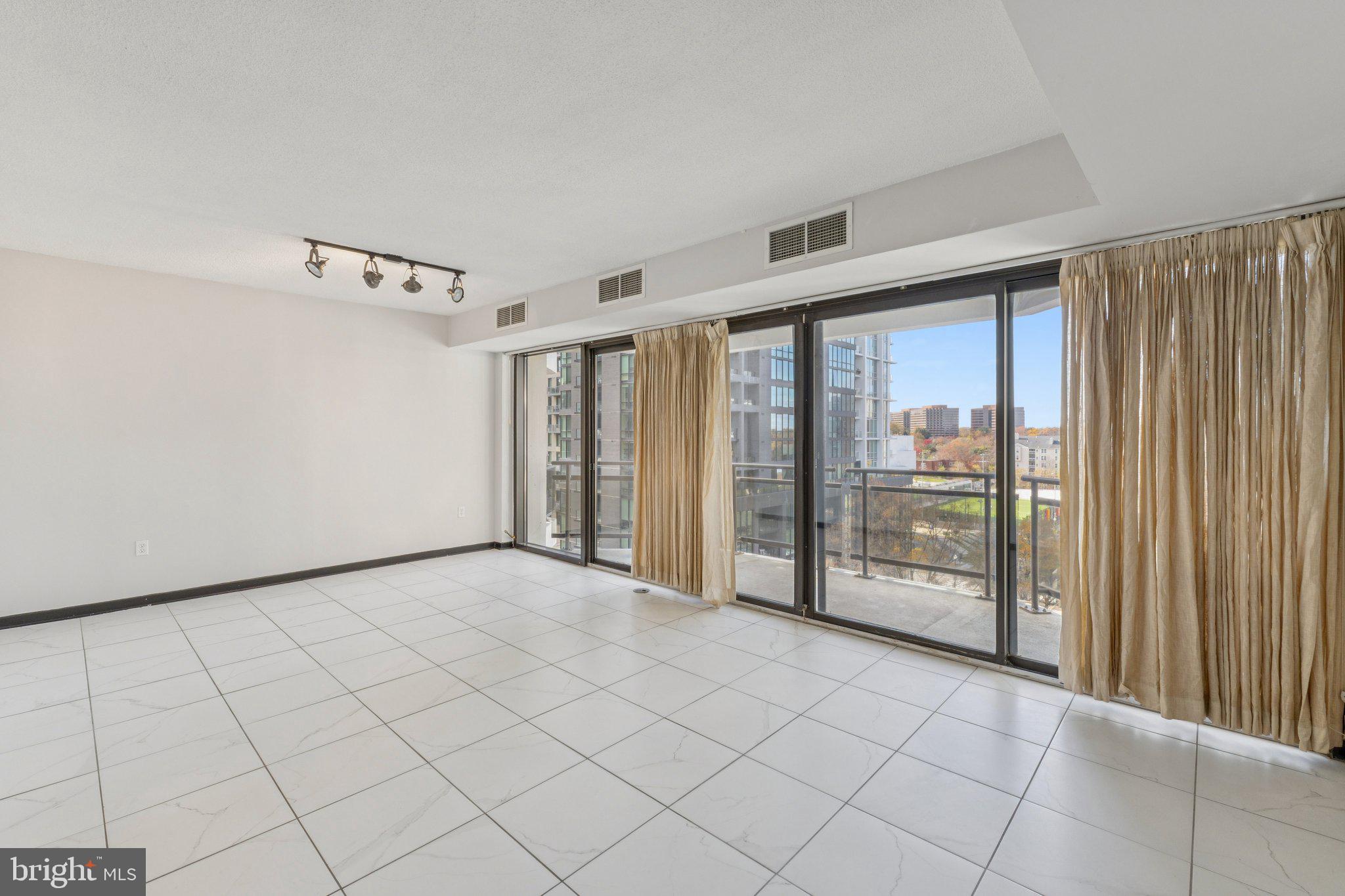 1530 Key Boulevard, Unit 929 Arlington, VA 22209 - Photo 5 of 37 a view of an empty room with windows
