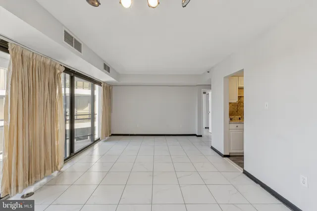 a view of a livingroom with an empty space and a window