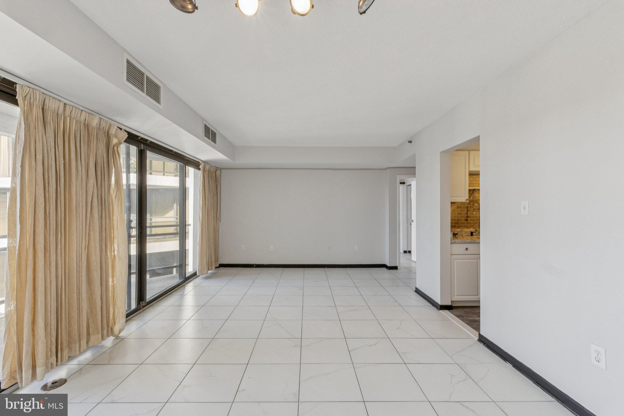 1530 Key Boulevard, Unit 929 Arlington, VA 22209 - Photo 8 of 37 a view of a livingroom with an empty space and a window