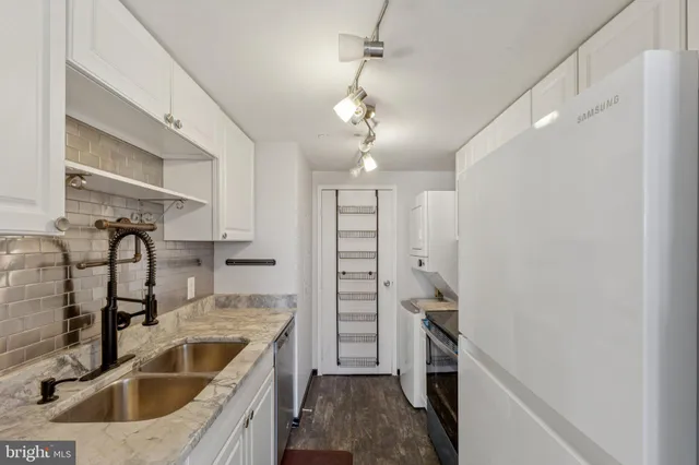 a kitchen with a sink and a refrigerator