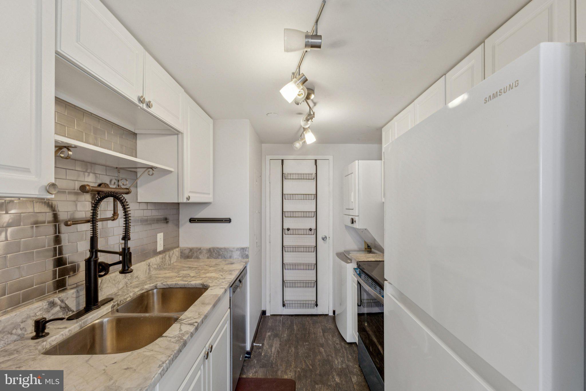 1530 Key Boulevard, Unit 929 Arlington, VA 22209 - Photo 10 of 37 a kitchen with a sink and a refrigerator