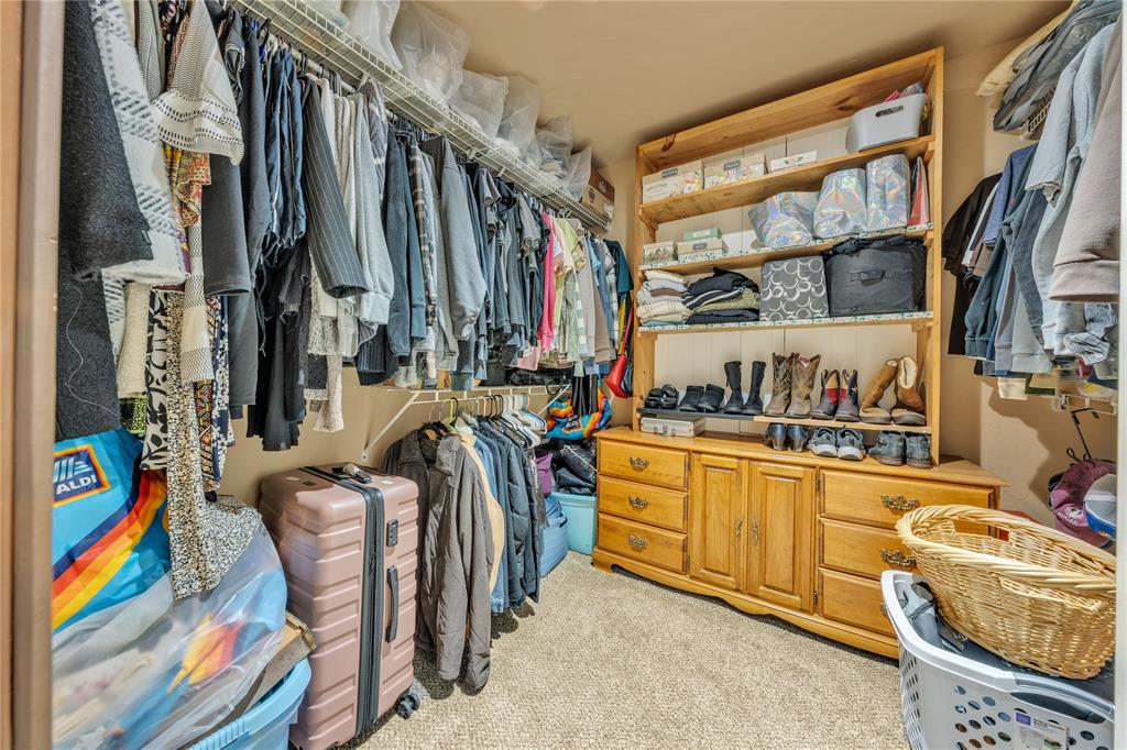 209 Dixie Road Millsap, TX 76066 - Photo 27 of 31 a view of walk in closet with clothes and shoes