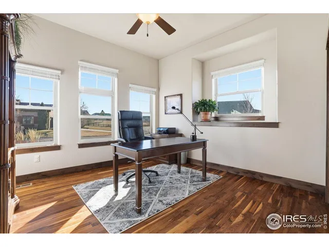 a workspace with wooden floor and a window