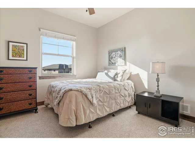 a bedroom with a bed and a night stand