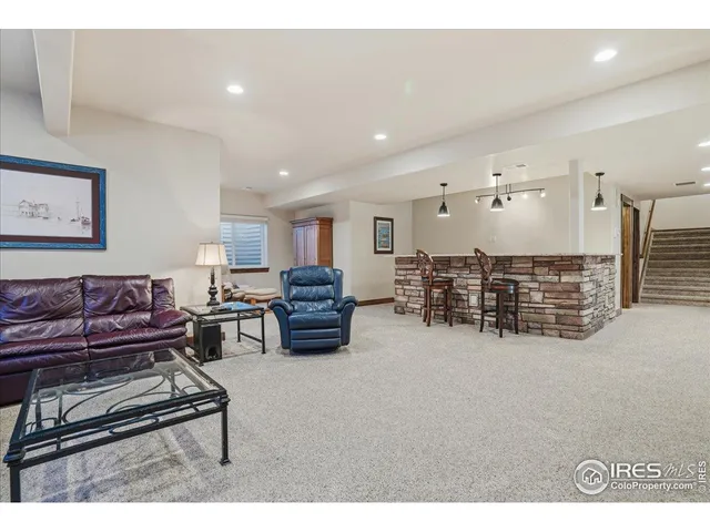a living room with furniture a couch and kitchen view