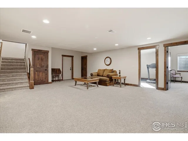a living room with furniture and gym equipment