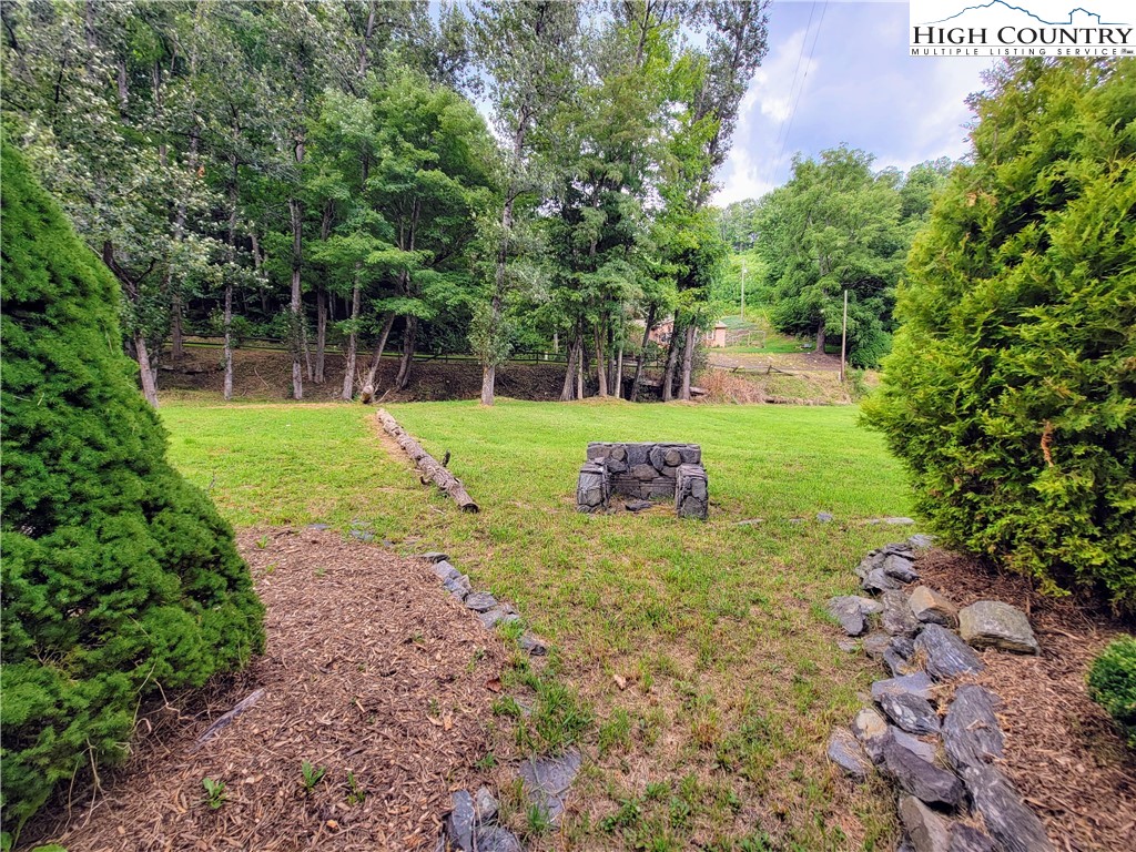West Mill Creek Road Warrensville, NC 28693 - Photo 12 of 13 a view of a backyard with large trees and plants