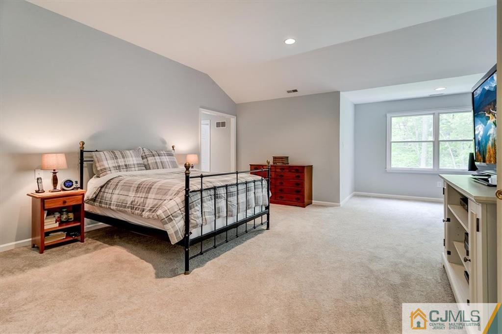 76 Bennett Road Old Bridge, NJ 07747 - Photo 15 of 23 a bedroom with a bed and a table in it