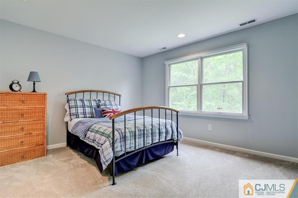 76 Bennett Road Old Bridge, NJ 07747 - Photo 19 of 23 a bed sitting in a bedroom next to a window