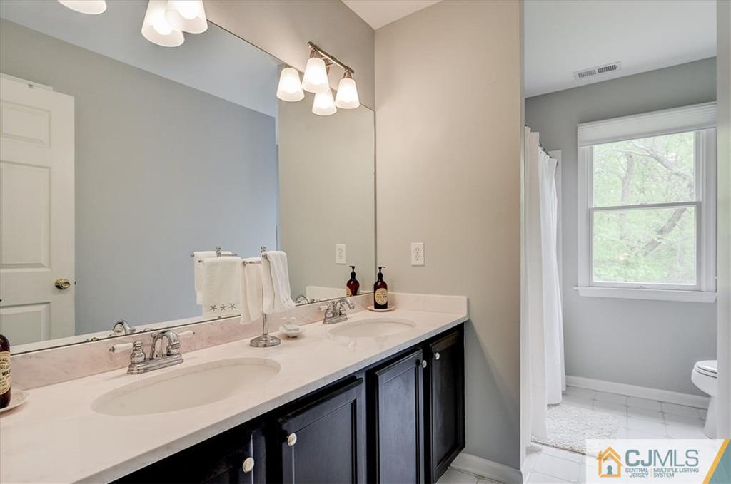 76 Bennett Road Old Bridge, NJ 07747 - Photo 21 of 23 a bathroom with a sink double vanity and a mirror