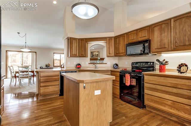 9737 Rockingham Drive Peyton, CO 80831 - Photo 10 of 28 ~Another view of the kitchen and how nicely it flows into the Living Room/Dining area~