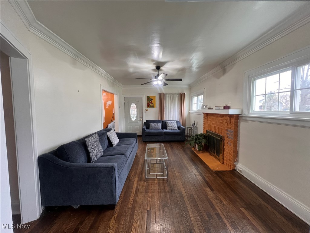 1686 Avalon Road Cleveland, OH 44112 - Photo 5 of 22 Living room with ceiling fan, a brick fireplace, and dark wood-type flooring