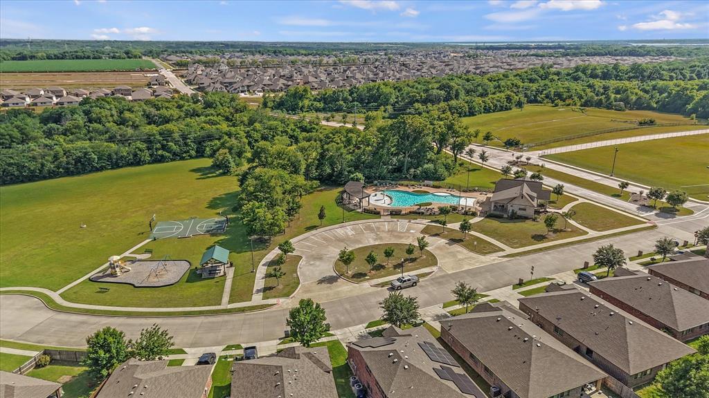 409 Harding Lane Lavon, TX 75166 - Photo 33 of 34 Expansive green space featuring a playground, basketball court, and mature trees