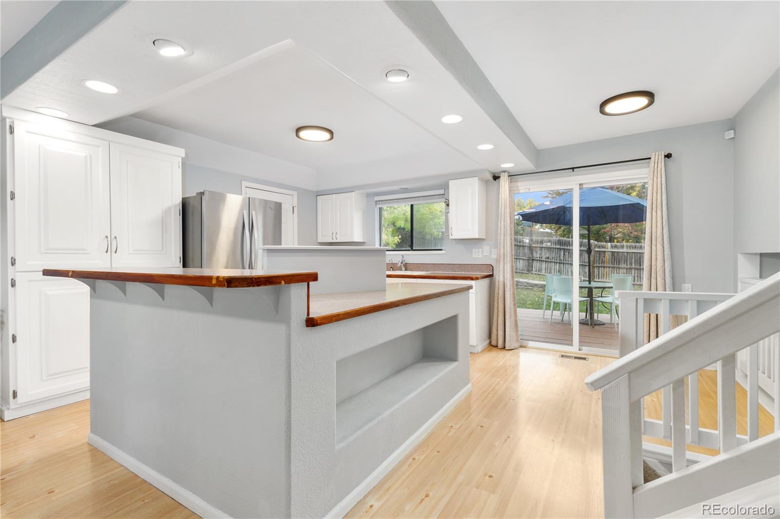 11841 West Dumbarton Drive Morrison, CO 80465 - Photo 12 of 45 a large white kitchen with a large window