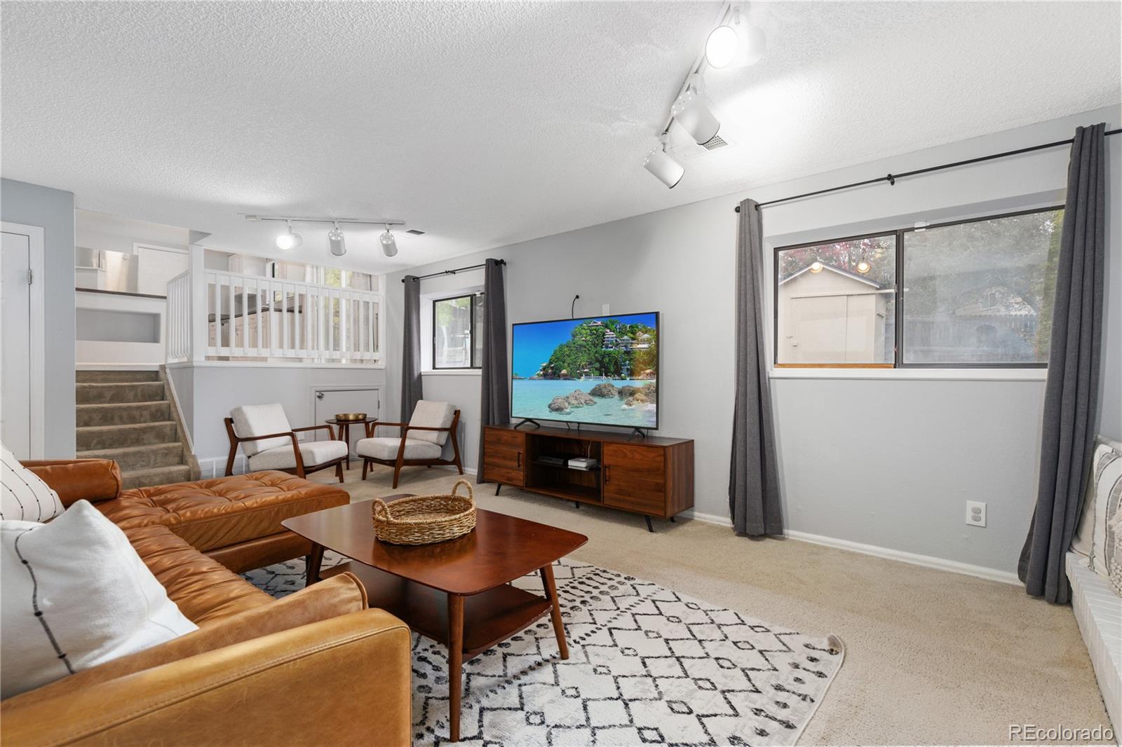 11841 West Dumbarton Drive Morrison, CO 80465 - Photo 13 of 45 a living room with furniture and a flat screen tv