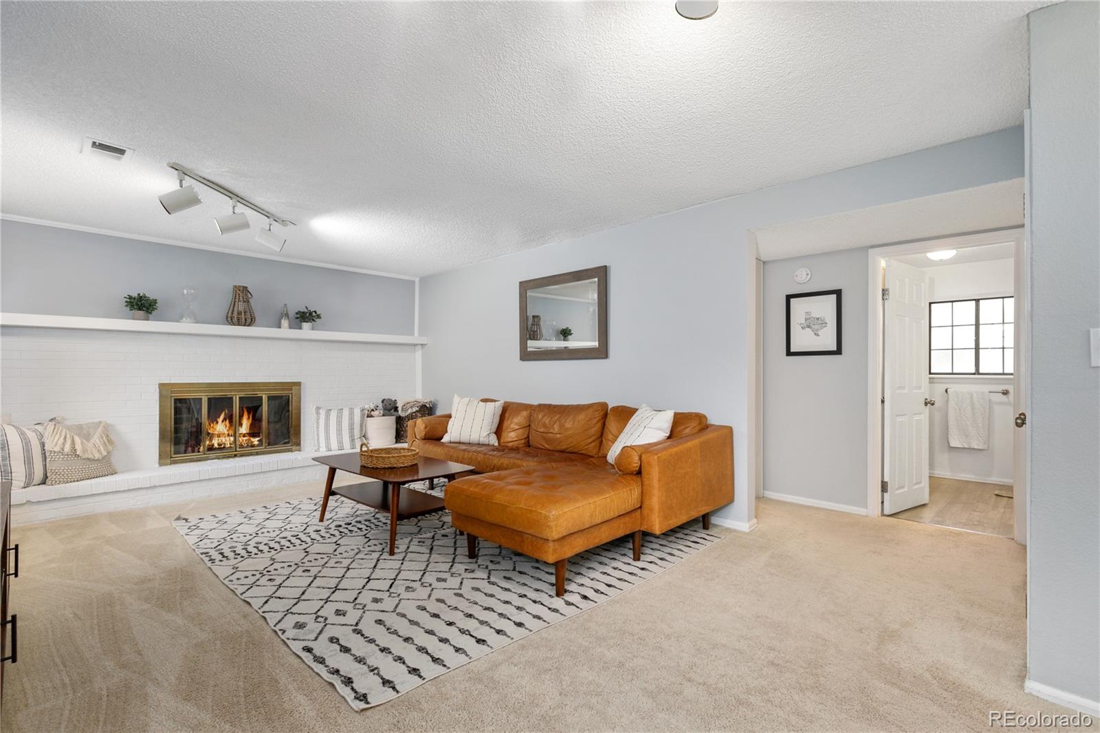 11841 West Dumbarton Drive Morrison, CO 80465 - Photo 15 of 45 a living room with furniture and a fireplace