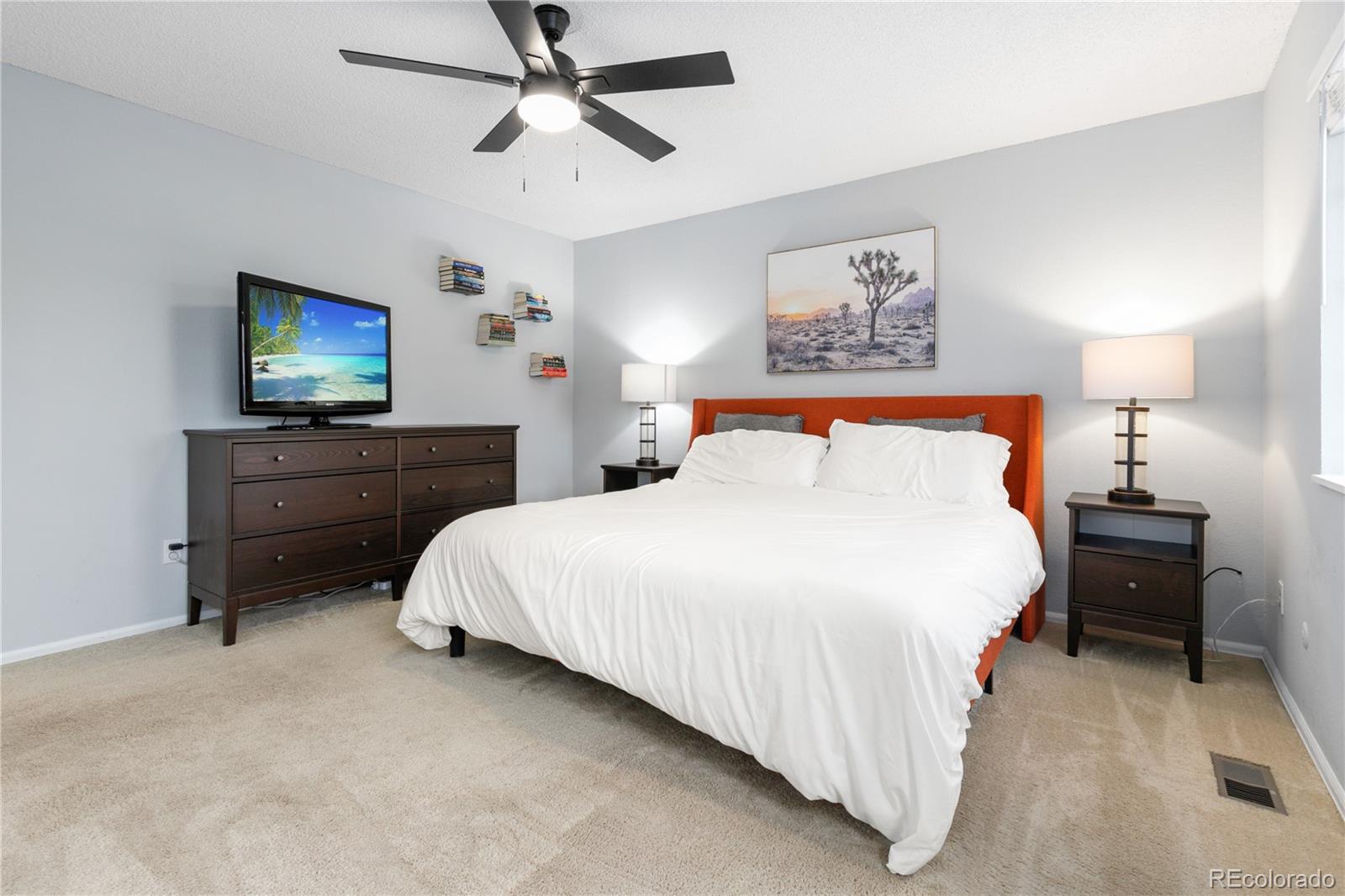 11841 West Dumbarton Drive Morrison, CO 80465 - Photo 16 of 45 a bedroom with a bed and a chandelier