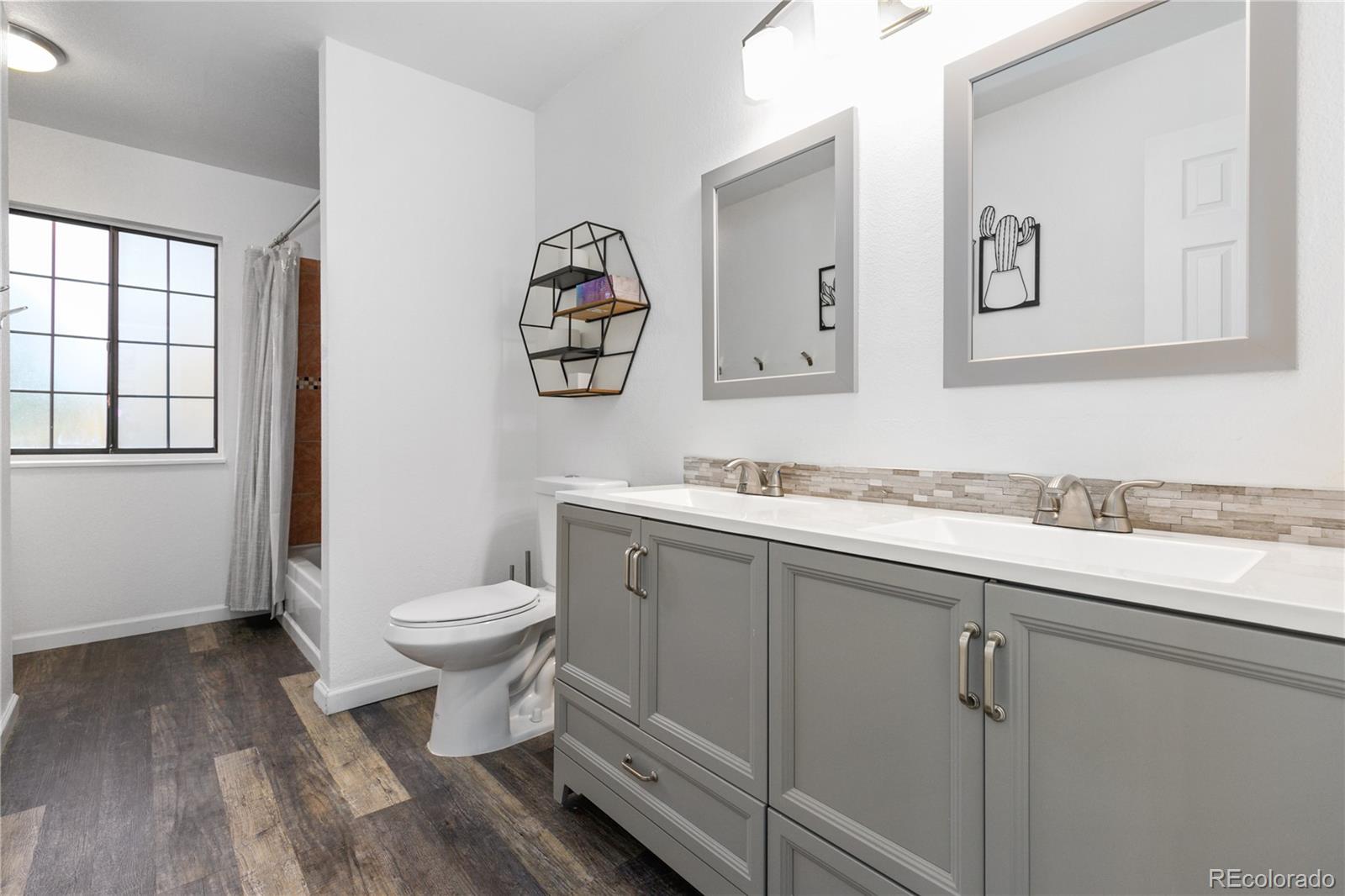 11841 West Dumbarton Drive Morrison, CO 80465 - Photo 19 of 45 a bathroom with a toilet sink and mirror