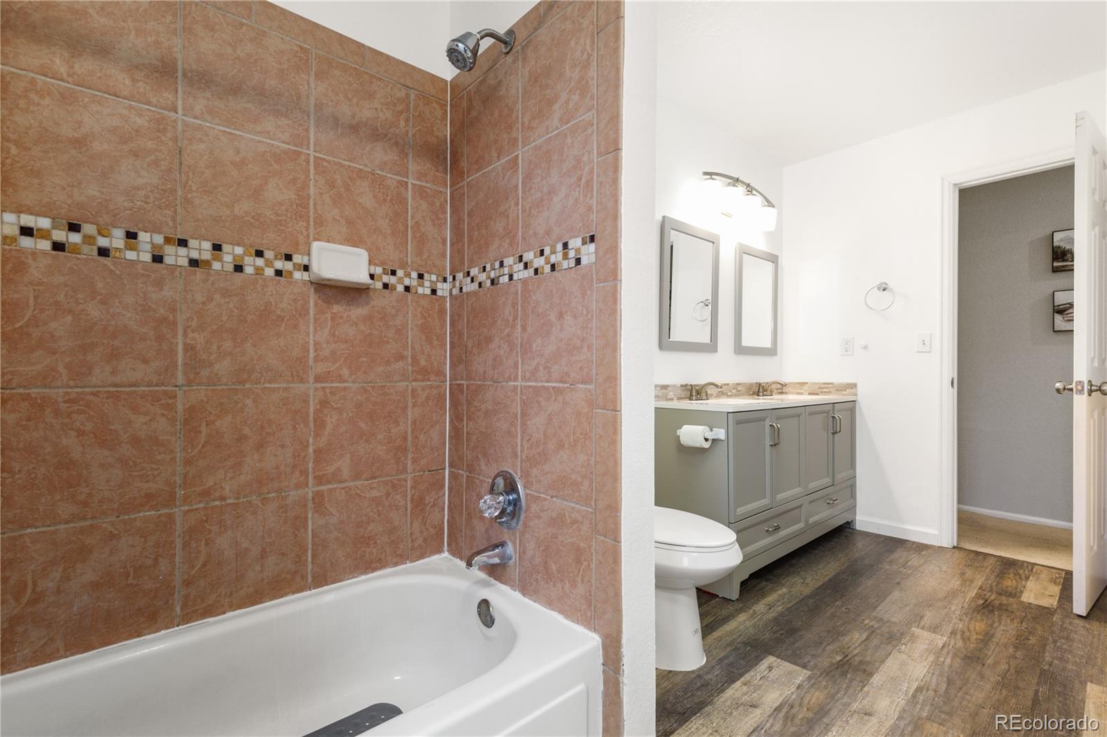 11841 West Dumbarton Drive Morrison, CO 80465 - Photo 20 of 45 a bathroom with a sink a toilet and shower