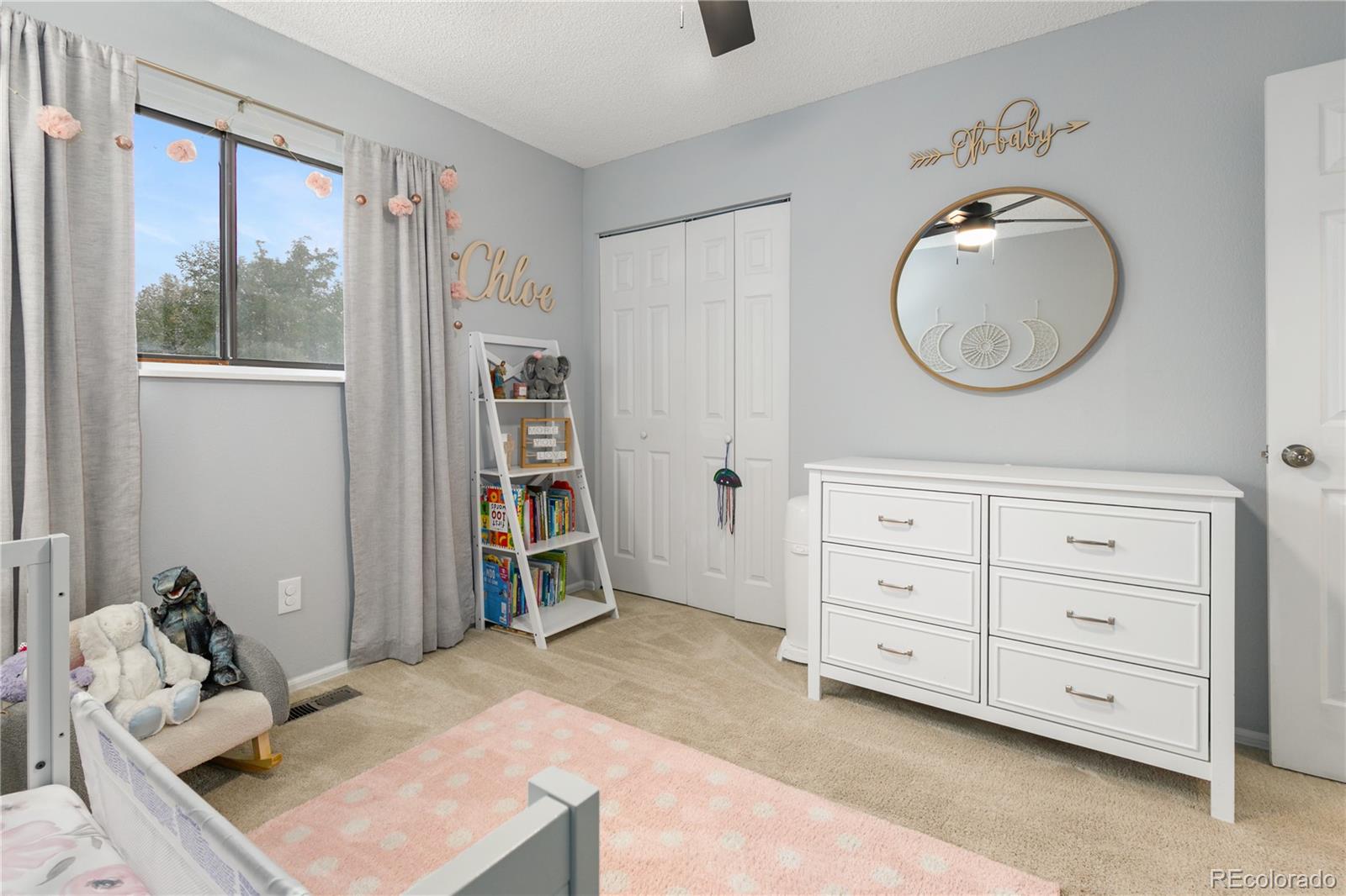 11841 West Dumbarton Drive Morrison, CO 80465 - Photo 22 of 45 a bedroom with a bed and a mirror on the dresser