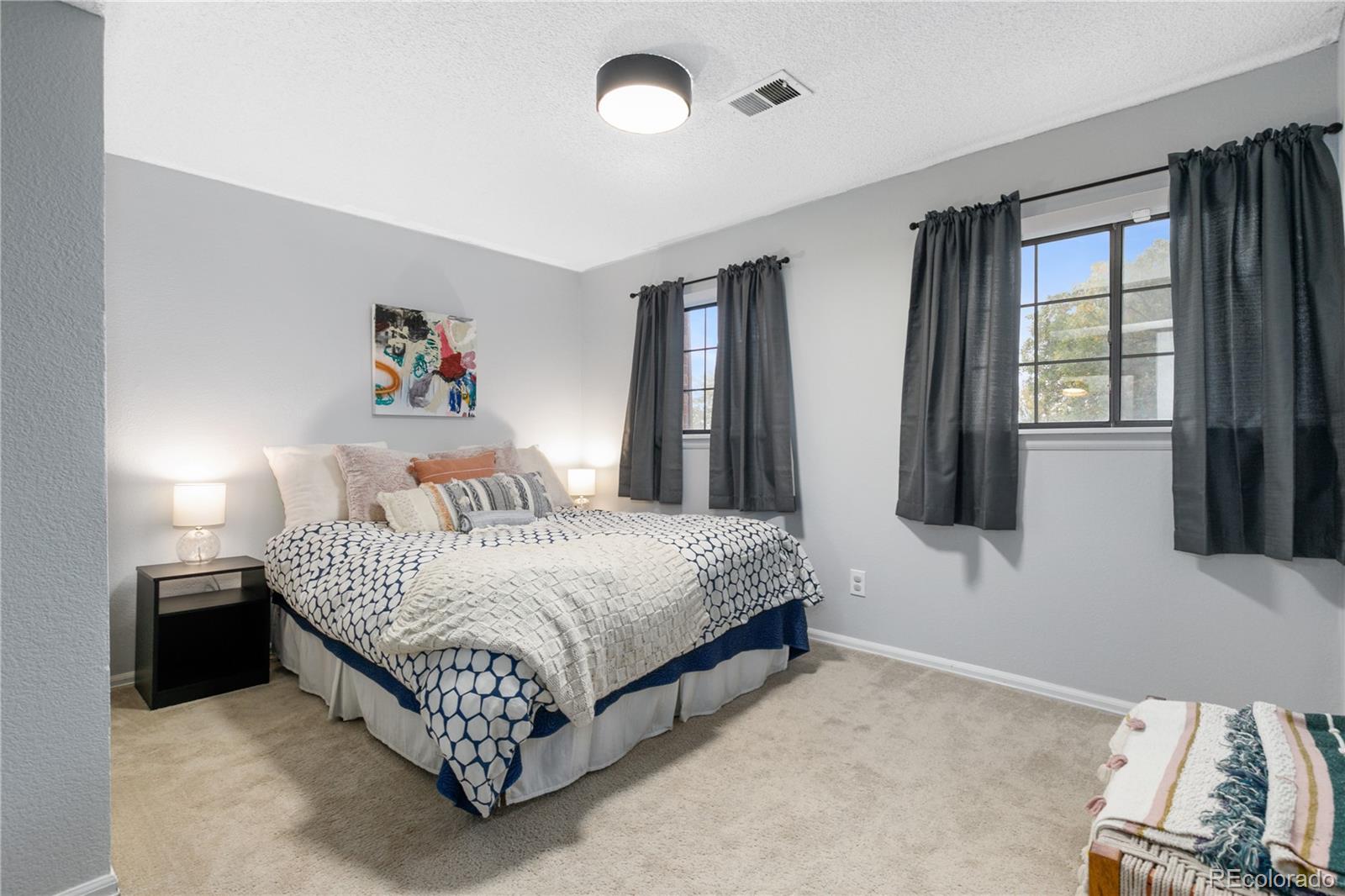 11841 West Dumbarton Drive Morrison, CO 80465 - Photo 24 of 45 a spacious bedroom with a bed and a window