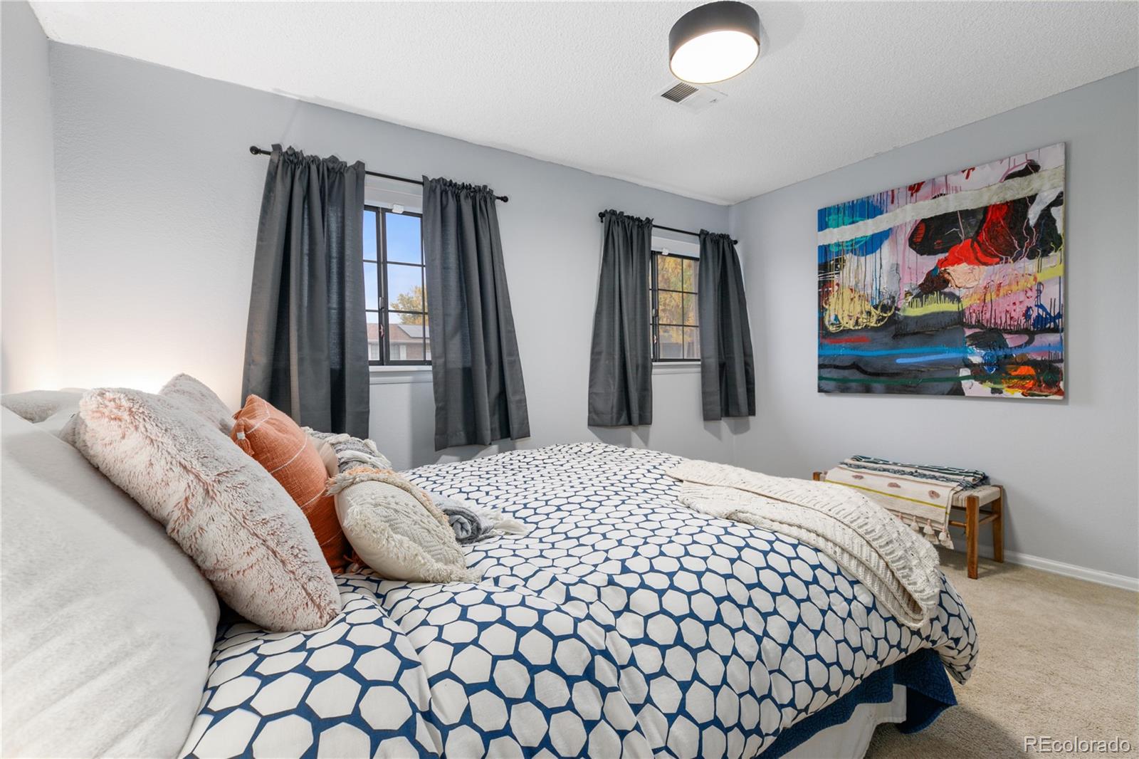 11841 West Dumbarton Drive Morrison, CO 80465 - Photo 25 of 45 a bedroom with a bed and a painting on the wall