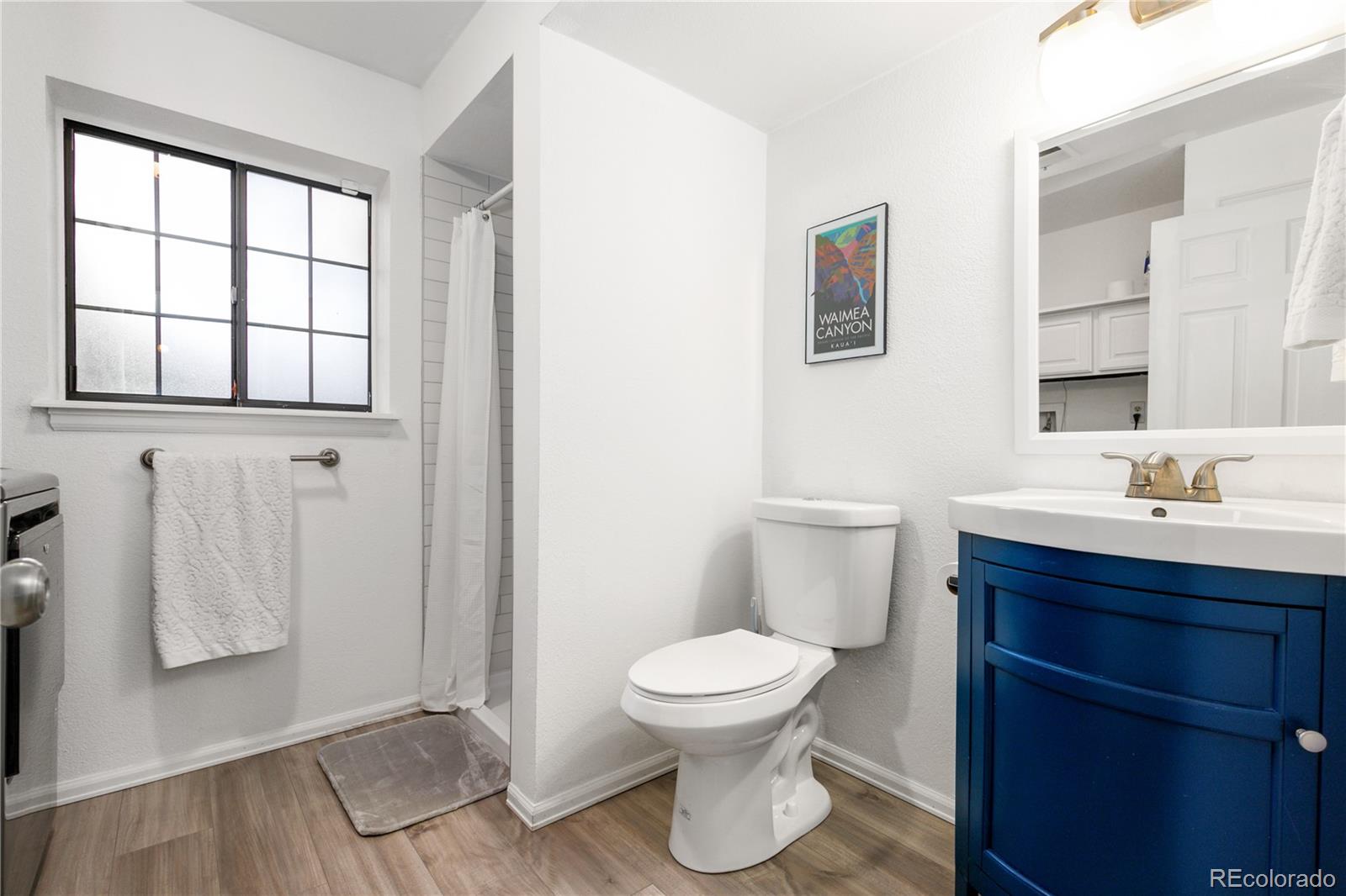 11841 West Dumbarton Drive Morrison, CO 80465 - Photo 26 of 45 a bathroom with a toilet sink and a mirror