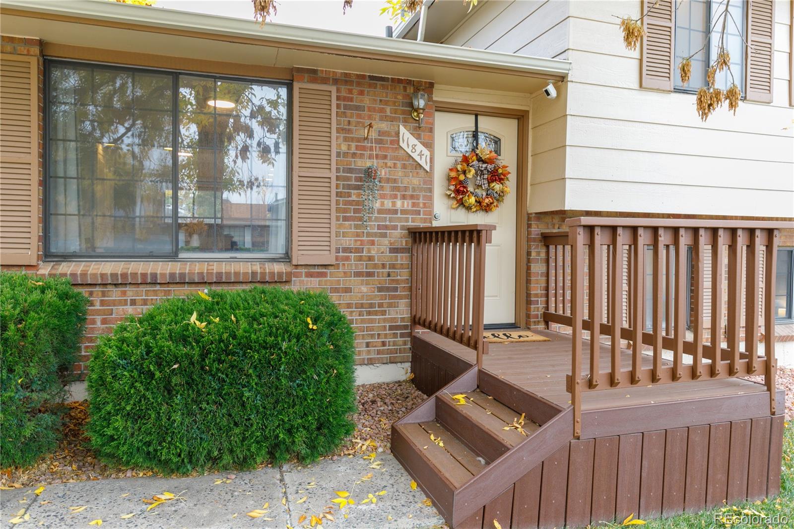 11841 West Dumbarton Drive Morrison, CO 80465 - Photo 5 of 45 a front view of a house with a garden