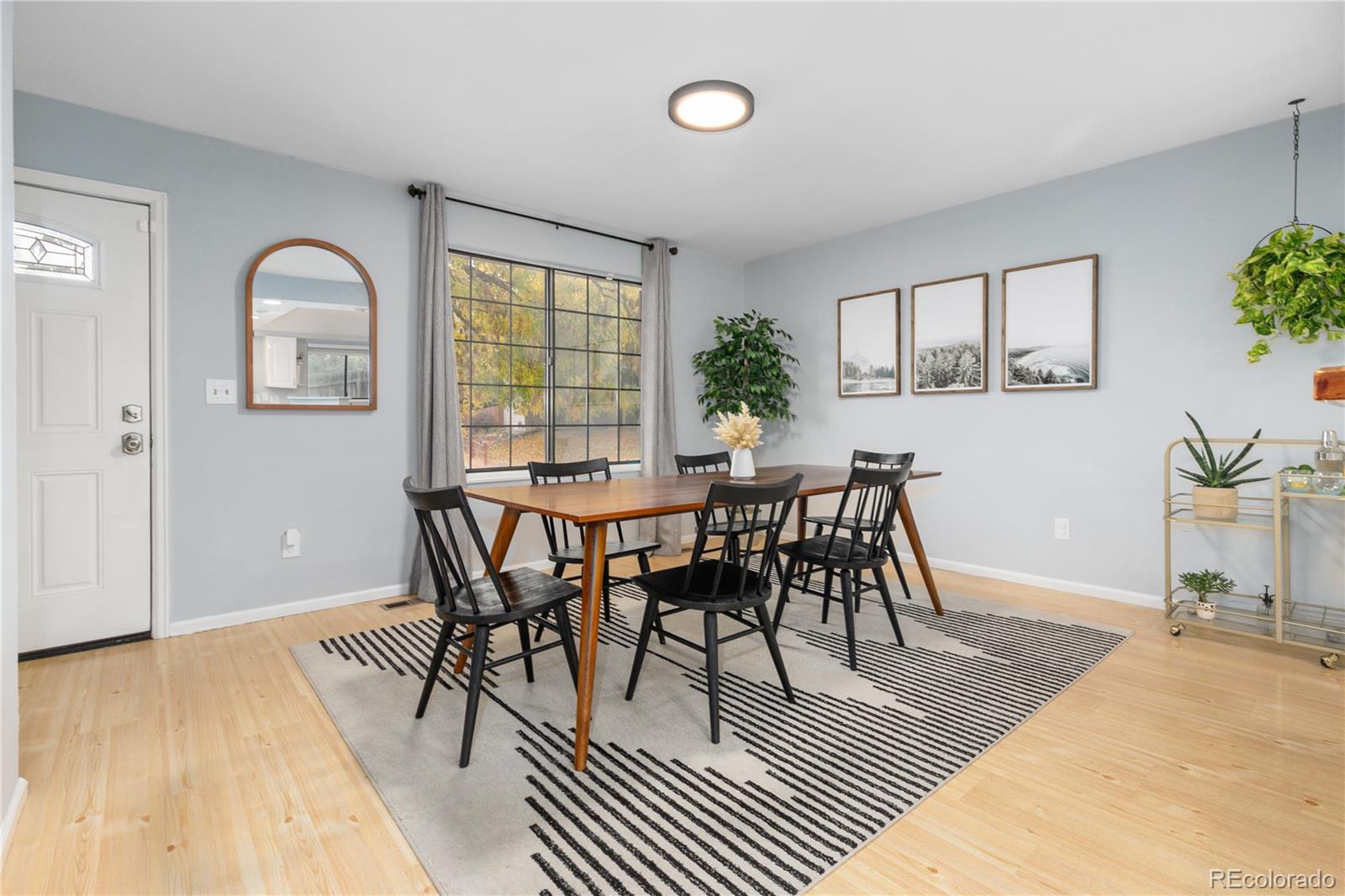 11841 West Dumbarton Drive Morrison, CO 80465 - Photo 7 of 45 a dining room with furniture potted plants and wooden floor
