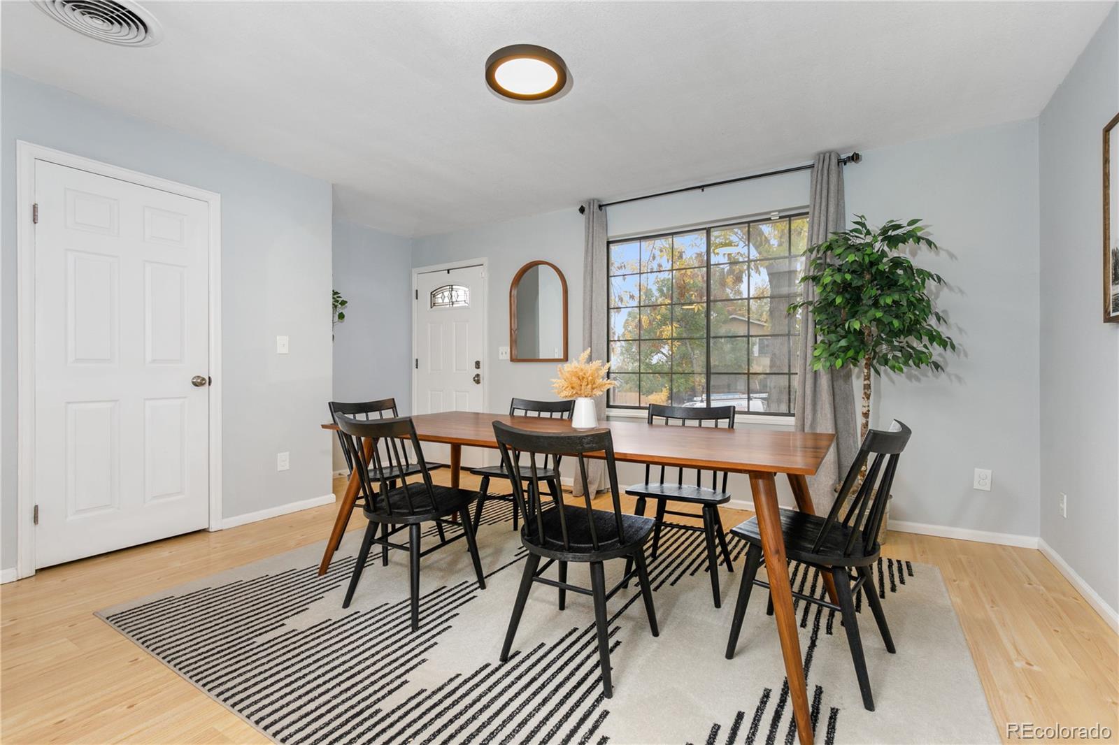 11841 West Dumbarton Drive Morrison, CO 80465 - Photo 9 of 45 a view of a dining room with furniture and wooden floor