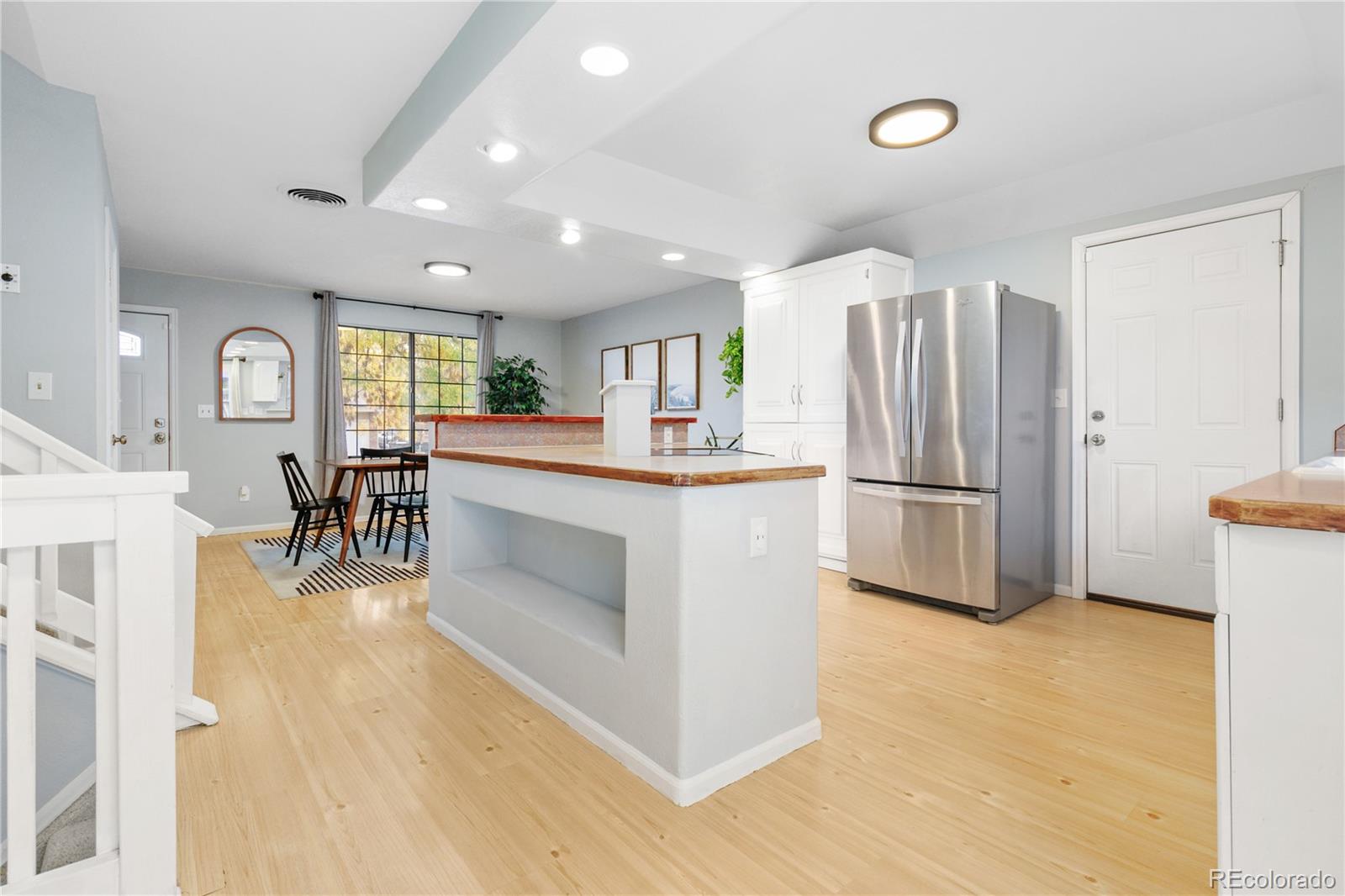 11841 West Dumbarton Drive Morrison, CO 80465 - Photo 10 of 45 a kitchen with stainless steel appliances a refrigerator and a stove top oven