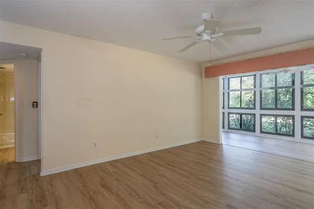 wooden floor in an empty room with a window