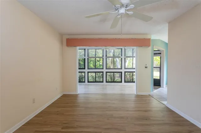 wooden floor in an empty room with a window