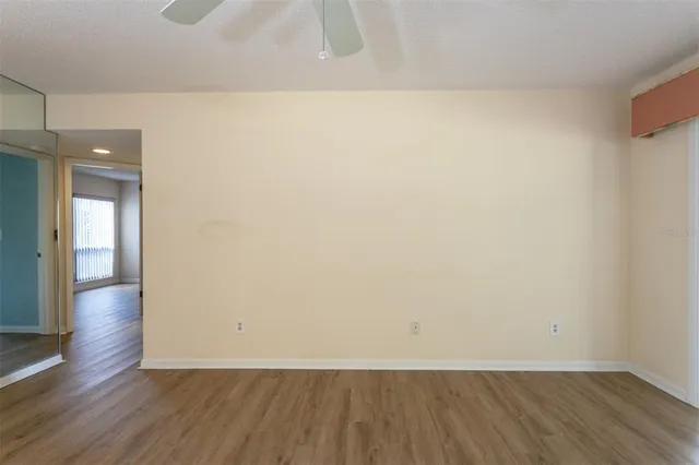 a view of an empty room and wooden floor