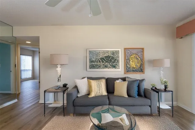 a living room with furniture and a painting on the wall