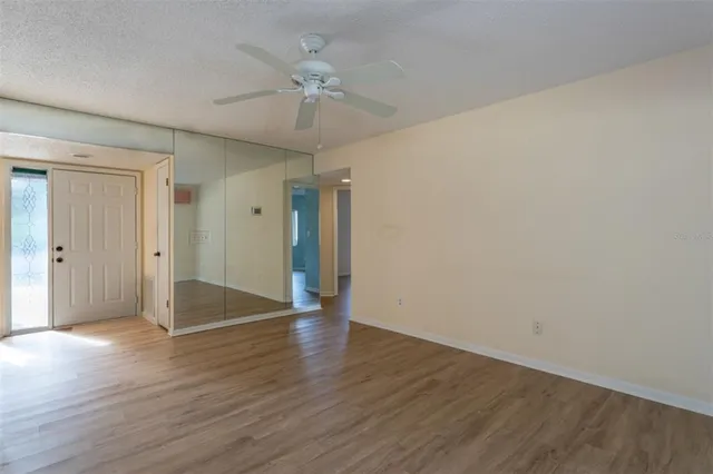 a view of an empty room with wooden floor