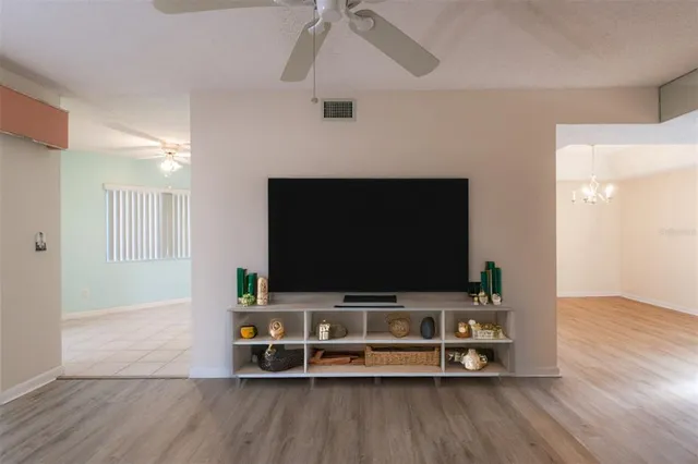 a living room with table and flat screen tv