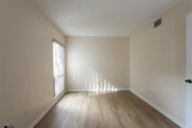 a view of wooden floor and windows in a room