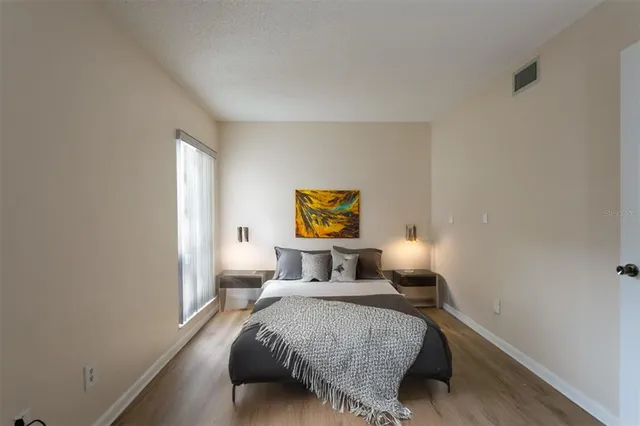 a bedroom with a bed and window