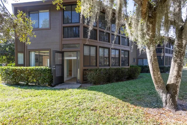 a view of a house with a yard and plants