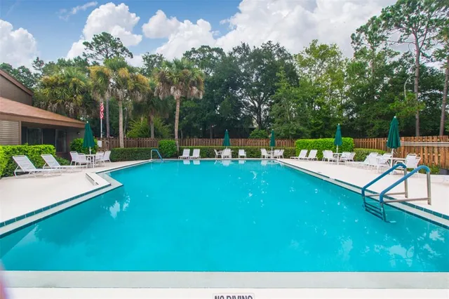 a view of a house with a backyard patio and sitting area