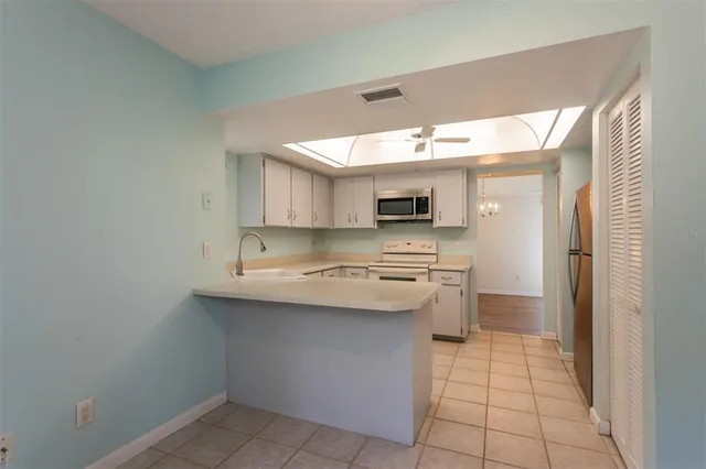 a kitchen with stainless steel appliances a sink stove and cabinets