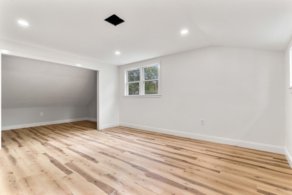 20 Dudley Road Wayland, MA 01778 - Photo 17 of 27 a view of an empty room with wooden floor and a window