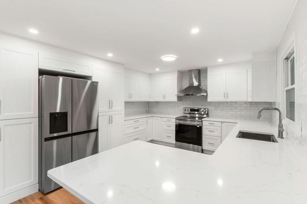 20 Dudley Road Wayland, MA 01778 - Photo 2 of 27 a kitchen with granite countertop a refrigerator stove top oven and sink