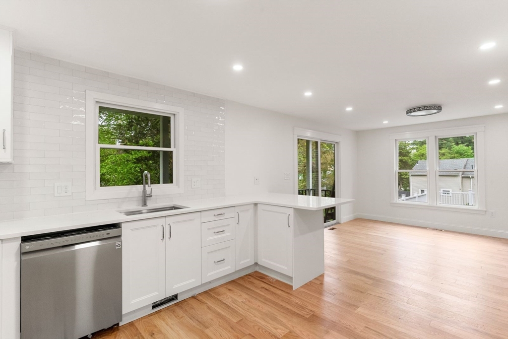 20 Dudley Road Wayland, MA 01778 - Photo 4 of 27 a kitchen with white cabinets and wooden floors