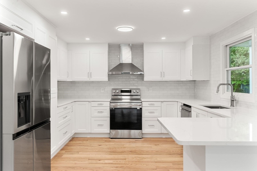 20 Dudley Road Wayland, MA 01778 - Photo 5 of 27 a kitchen with stainless steel appliances a stove sink and refrigerator